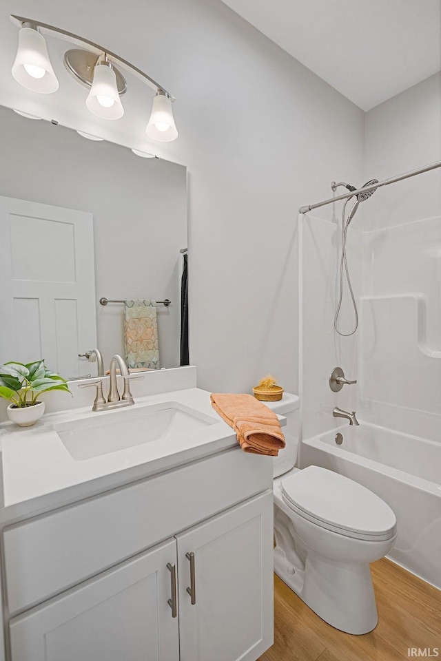 2487 Fiona Dr, Kokomo, IN 46902 - bathroom with vanity, wood finished floors, toilet, and shower / bathtub combination