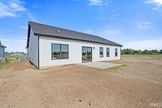 2487 Fiona Dr, Kokomo, IN 46902 - back of property featuring a patio, a shingled roof, and cooling unit