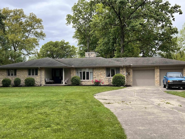 405 N Dogwood Ln, Muncie, IN 47304 - ranch-style house featuring stone siding, an attached garage, driveway, and a front yard