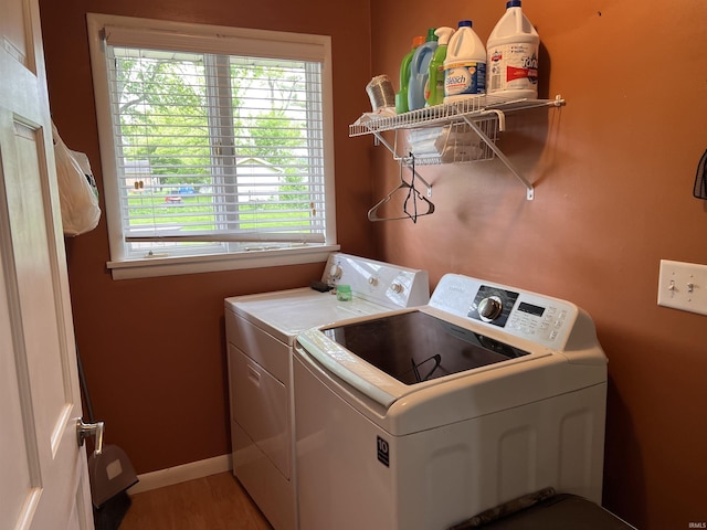 405 N Dogwood Ln, Muncie, IN 47304 - washroom featuring washing machine and clothes dryer, plenty of natural light, light wood-style flooring, and baseboards