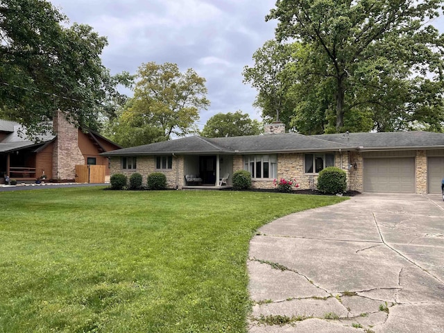 405 N Dogwood Ln, Muncie, IN 47304 - single story home with a chimney, an attached garage, a front yard, concrete driveway, and stone siding