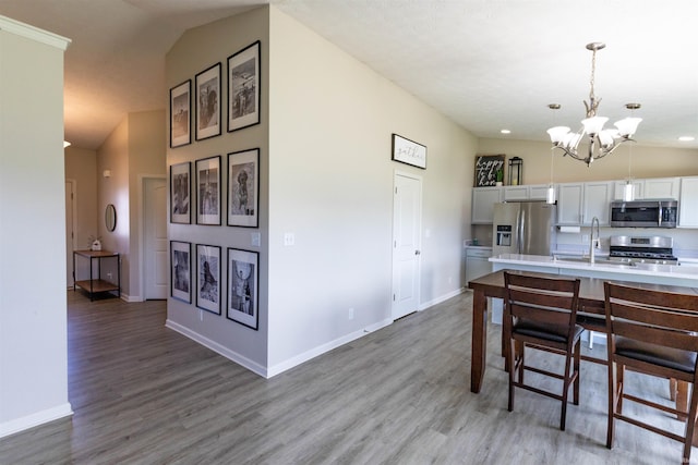 2141 Rutherford Dr, West Lafayette, IN 47906 - kitchen featuring stainless steel appliances, a chandelier, light countertops, light wood finished floors, and baseboards