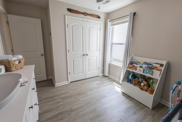 2141 Rutherford Dr, West Lafayette, IN 47906 - playroom featuring light wood-type flooring, baseboards, and a sink