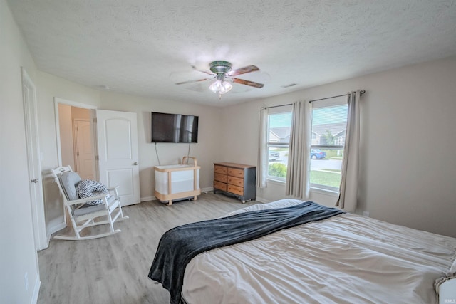 2141 Rutherford Dr, West Lafayette, IN 47906 - bedroom featuring light wood-type flooring, baseboards, ceiling fan, and a textured ceiling
