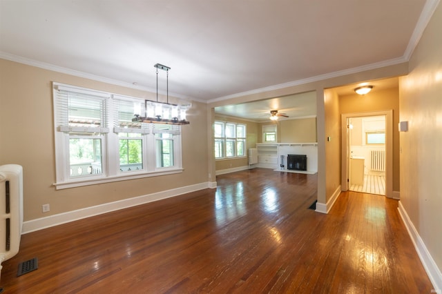 3601 Stringtown Rd, Evansville, IN 47711 - unfurnished living room featuring radiator, hardwood / wood-style flooring, ornamental molding, a fireplace, and baseboards