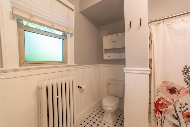 3601 Stringtown Rd, Evansville, IN 47711 - full bath featuring radiator heating unit, a wainscoted wall, toilet, and a shower with shower curtain