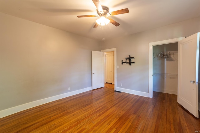 3601 Stringtown Rd, Evansville, IN 47711 - unfurnished bedroom featuring hardwood / wood-style flooring, a closet, baseboards, and ceiling fan