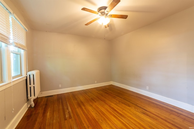 3601 Stringtown Rd, Evansville, IN 47711 - spare room featuring radiator, wood finished floors, a ceiling fan, and baseboards