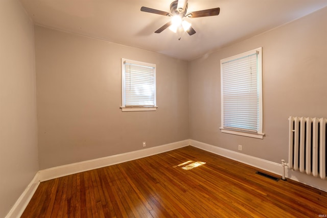 3601 Stringtown Rd, Evansville, IN 47711 - empty room featuring radiator, baseboards, ceiling fan, and dark wood-style flooring