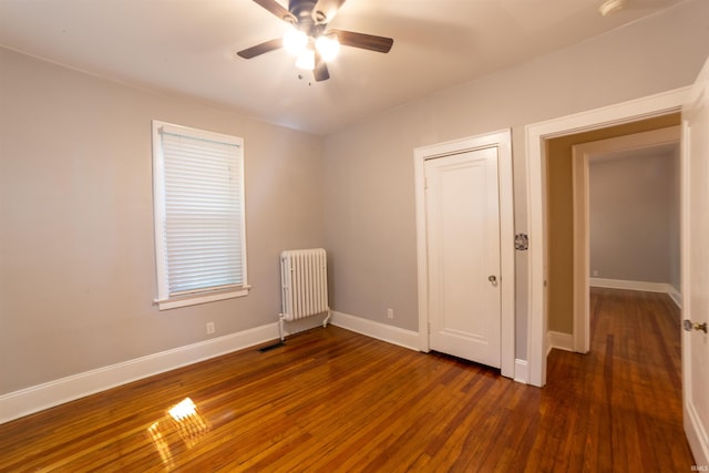 3601 Stringtown Rd, Evansville, IN 47711 - unfurnished bedroom with radiator heating unit, wood finished floors, baseboards, and a ceiling fan