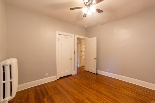 3601 Stringtown Rd, Evansville, IN 47711 - empty room featuring ceiling fan, wood-type flooring, baseboards, and radiator heating unit