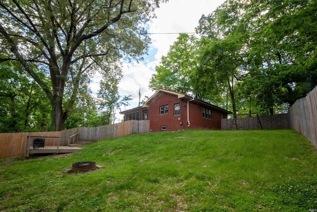 3601 Stringtown Rd, Evansville, IN 47711 - view of yard featuring an outdoor fire pit and a wooden deck