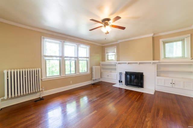 3601 Stringtown Rd, Evansville, IN 47711 - unfurnished living room featuring radiator heating unit, wood finished floors, a ceiling fan, ornamental molding, and a fireplace