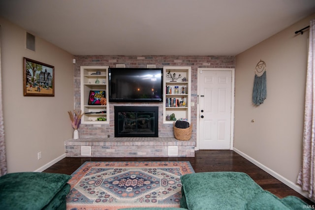 101 Hendron Hills Dr, Vincennes, IN 47591 - living room featuring baseboards, a fireplace, dark wood-style flooring, and built in shelves
