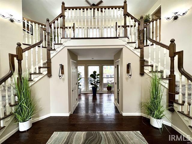 101 Hendron Hills Dr, Vincennes, IN 47591 - entryway featuring stairs, baseboards, wood finished floors, and a towering ceiling