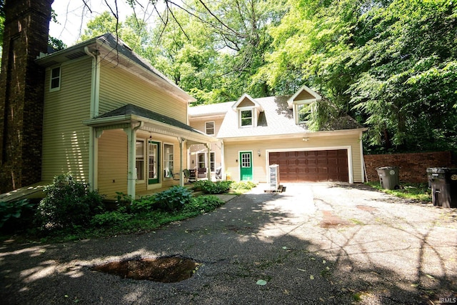 101 Hendron Hills Dr, Vincennes, IN 47591 - view of front of home with a porch, asphalt driveway, and a garage