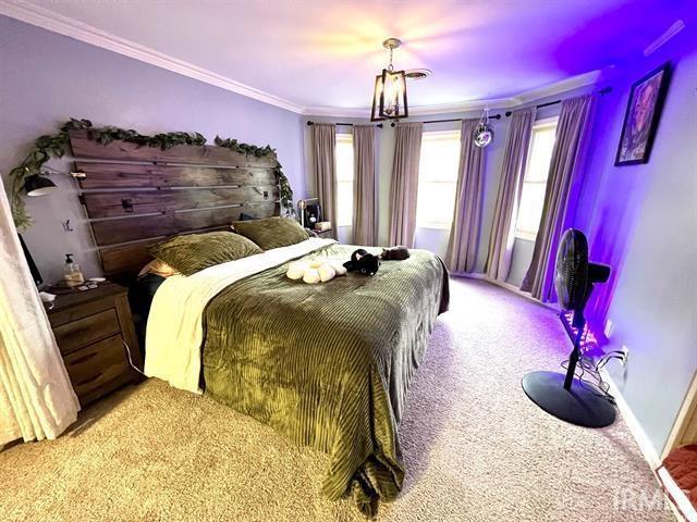 101 Hendron Hills Dr, Vincennes, IN 47591 - bedroom featuring crown molding, carpet flooring, multiple windows, and baseboards