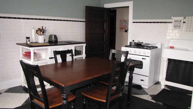 215 S Main St, Oakland City, IN 47660 - dining room featuring tile walls and tile patterned floors