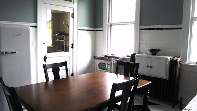 215 S Main St, Oakland City, IN 47660 - dining room featuring tile walls and a wainscoted wall