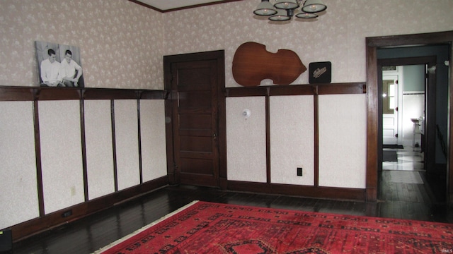 215 S Main St, Oakland City, IN 47660 - detailed view of wood finished floors, wallpapered walls, and a chandelier