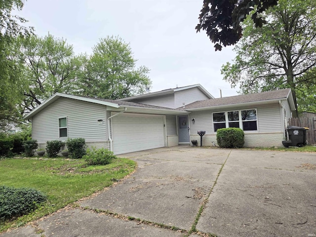 7823 Knightswood Dr, Fort Wayne, IN 46819 - view of front of home with brick siding, an attached garage, concrete driveway, and a shingled roof