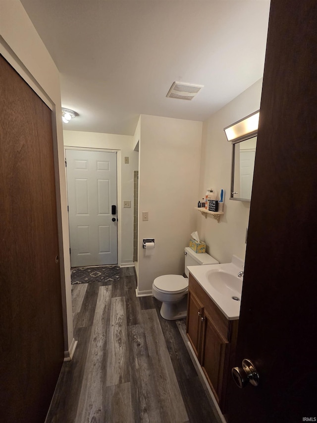 7823 Knightswood Dr, Fort Wayne, IN 46819 - bathroom featuring wood finished floors, vanity, toilet, and baseboards