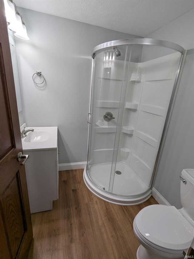 300 E Taylor St, Kokomo, IN 46901 - bathroom featuring wood finished floors, vanity, and a shower stall