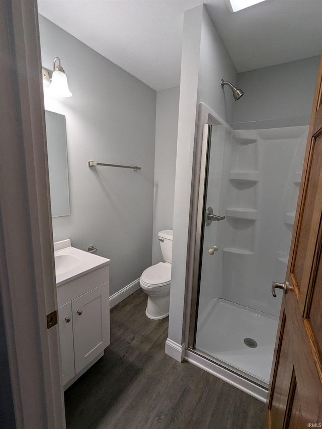 300 E Taylor St, Kokomo, IN 46901 - full bath featuring toilet, vanity, wood finished floors, a shower stall, and baseboards