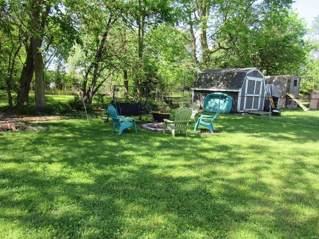 331 W Payton St, Greentown, IN 46936 - view of grassy yard with a fire pit and view of wooded area