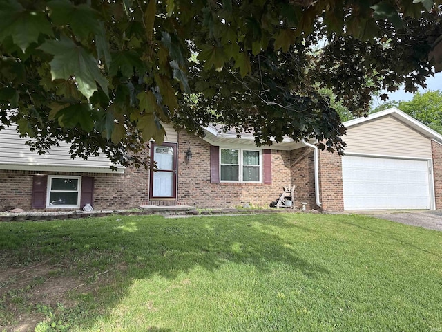 1913 Mckibben St, Wabash, IN 46992 - view of property hidden behind natural elements with brick siding, a front yard, an attached garage, and driveway