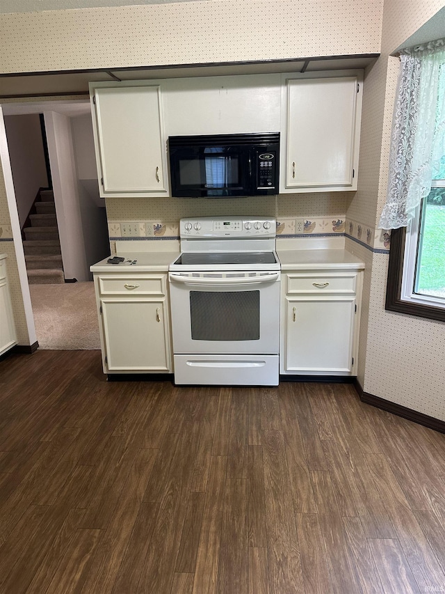1913 Mckibben St, Wabash, IN 46992 - kitchen featuring black microwave, white range with electric stovetop, wallpapered walls, dark wood-style flooring, and light countertops