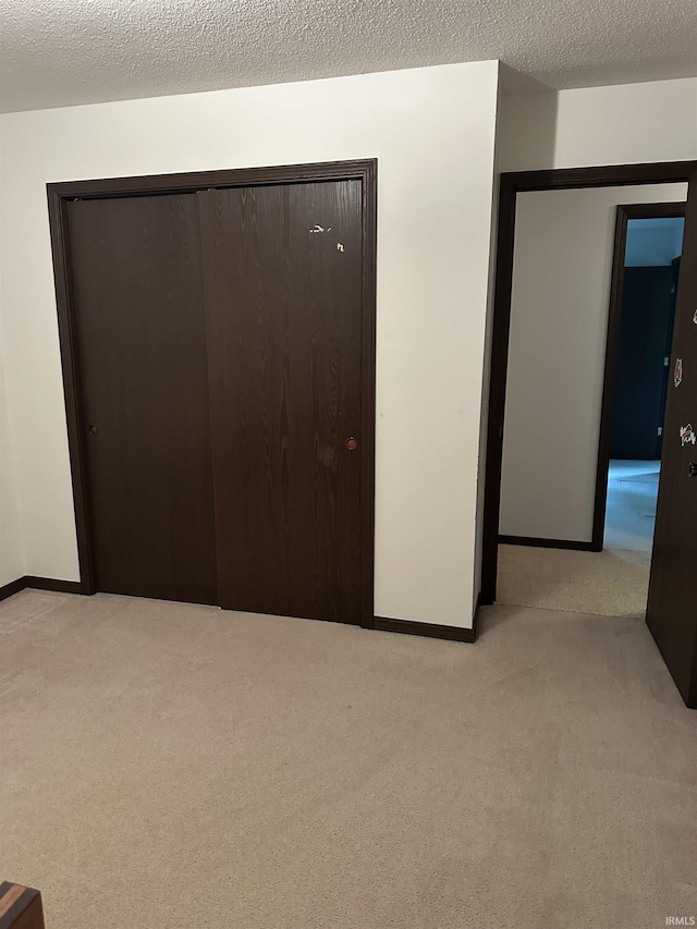 1913 Mckibben St, Wabash, IN 46992 - unfurnished bedroom featuring light carpet, a closet, and a textured ceiling