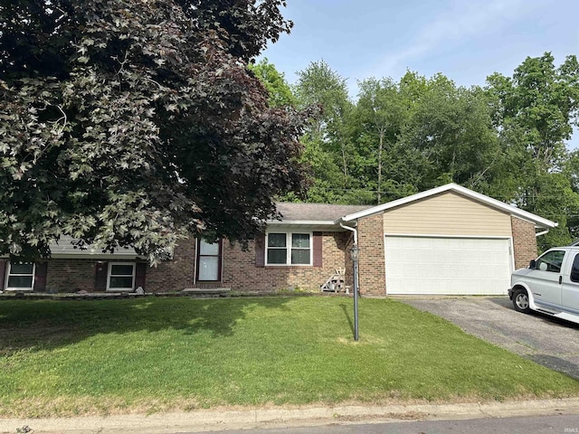 1913 Mckibben St, Wabash, IN 46992 - view of front of property with driveway, a garage, brick siding, and a front lawn