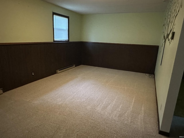 1913 Mckibben St, Wabash, IN 46992 - carpeted empty room featuring a wainscoted wall, a baseboard radiator, and wood walls