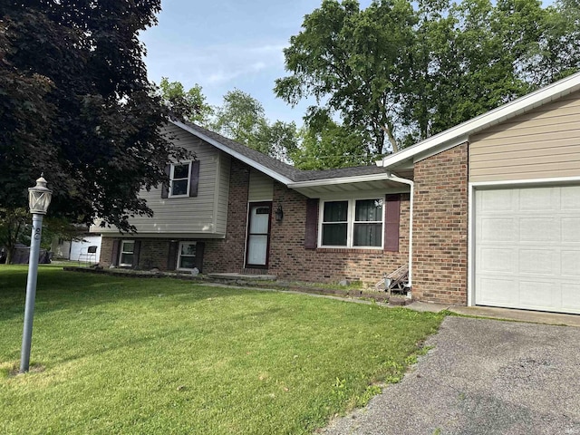 1913 Mckibben St, Wabash, IN 46992 - split level home with brick siding, a front yard, a garage, and asphalt driveway
