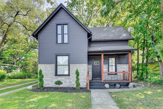 516 W Navarre St, South Bend, IN 46616 - view of front of home featuring stone siding, a shingled roof, covered porch, and a front lawn