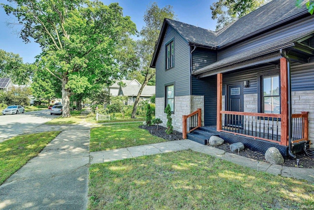 516 W Navarre St, South Bend, IN 46616 - view of side of home with stone siding and a yard