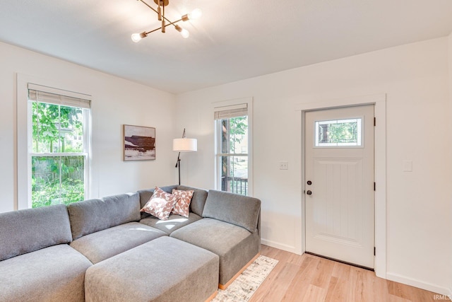 516 W Navarre St, South Bend, IN 46616 - living room with light wood-style floors, a chandelier, and baseboards