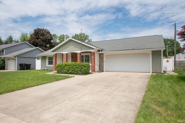 910 S Southland Dr, Lafayette, IN 47909 - single story home with an attached garage, driveway, brick siding, and a shingled roof