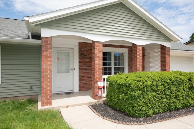 910 S Southland Dr, Lafayette, IN 47909 - entrance to property with brick siding, a garage, and roof with shingles