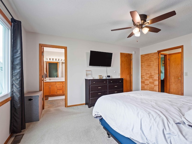 3335 Firethorne Ct, Fort Wayne, IN 46814 - bedroom with light colored carpet, baseboards, ensuite bathroom, a ceiling fan, and a sink