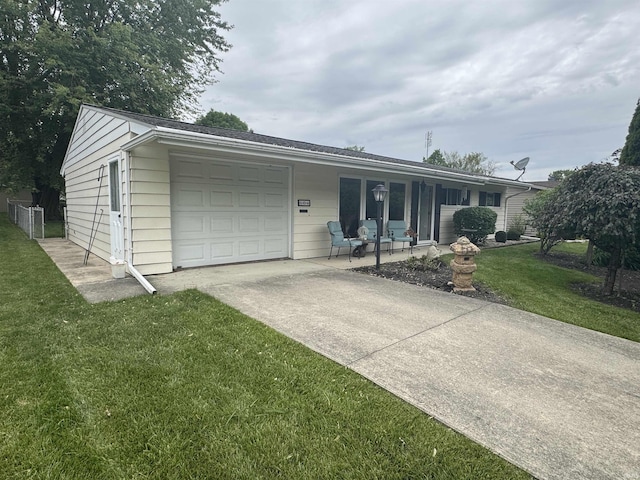 504 S Stratton Way, Decatur, IN 46733 - ranch-style home with an attached garage, concrete driveway, a front yard, and covered porch