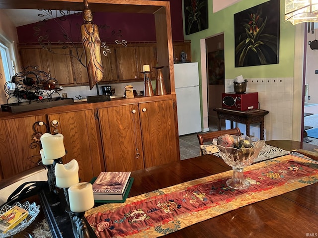 504 S Stratton Way, Decatur, IN 46733 - kitchen featuring freestanding refrigerator, brown cabinets, and tile walls