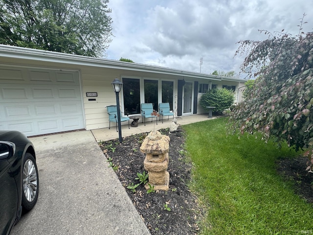 504 S Stratton Way, Decatur, IN 46733 - view of front of home with concrete driveway, an attached garage, and a front yard