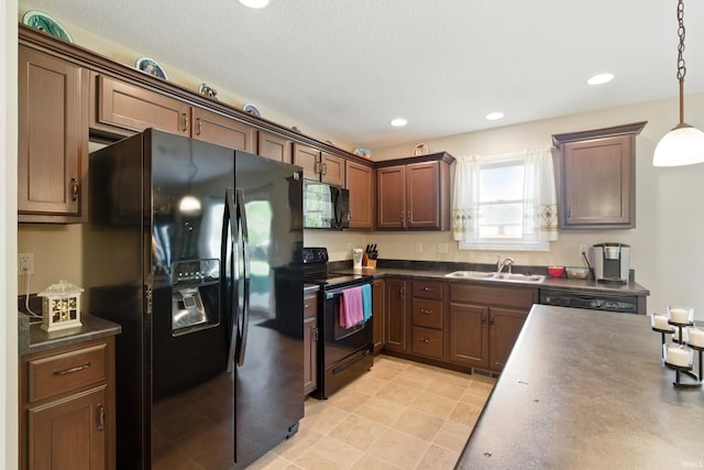 4679 Legacy Cv, Woodburn, IN 46797 - kitchen featuring black appliances, dark countertops, a sink, hanging light fixtures, and recessed lighting