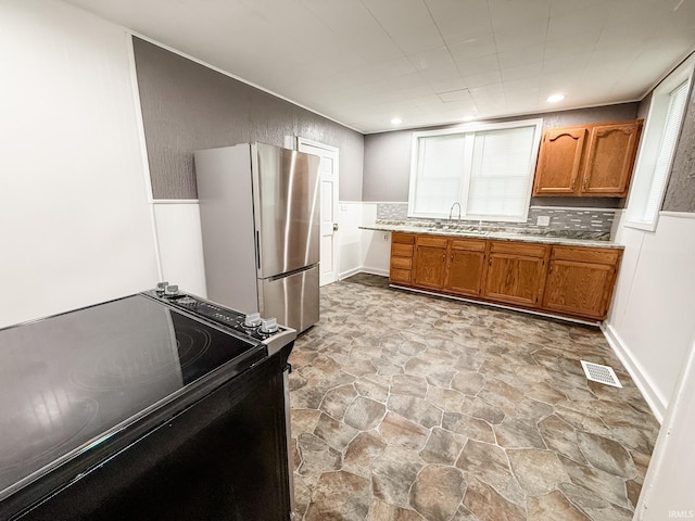1226 N Union St, Kokomo, IN 46901 - kitchen featuring freestanding refrigerator, black range with electric cooktop, light stone finish floors, brown cabinets, and light countertops
