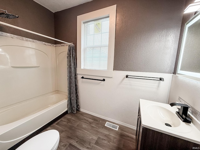 1226 N Union St, Kokomo, IN 46901 - full bathroom featuring wood finished floors, shower / bath combo with shower curtain, toilet, vanity, and baseboards