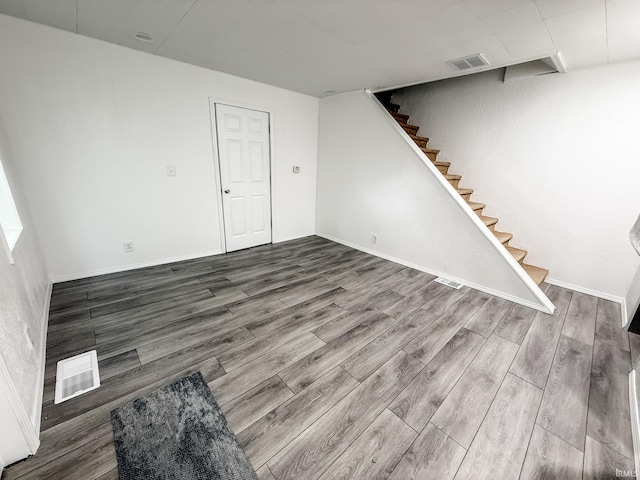 1226 N Union St, Kokomo, IN 46901 - unfurnished living room with stairs, wood finished floors, and baseboards