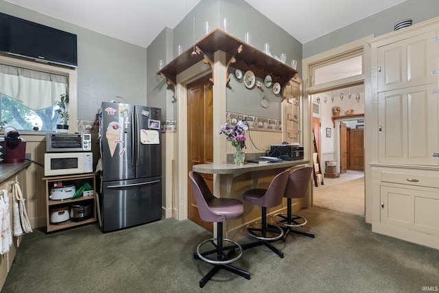 111 N State St, South Whitley, IN 46787 - kitchen featuring freestanding refrigerator, carpet, and white microwave