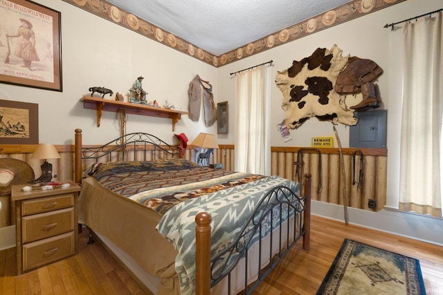 111 N State St, South Whitley, IN 46787 - bedroom with electric panel, wood finished floors, and a textured ceiling
